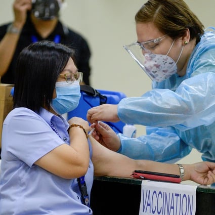 A health worker conducts a mock Covid-19 vaccination during a simulation exercise in Manila. Photo: Reuters