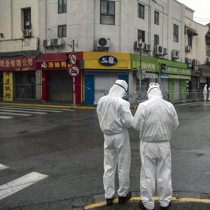 Police officers wearing personal protective equipment on the streets of Shanghai. Photo: Bloomberg