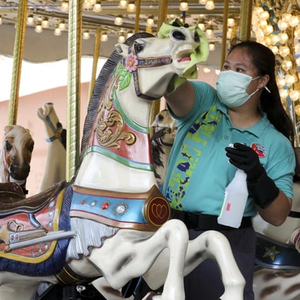 An employee disinfects an Ocean Park roundabout on September 18, 2020, after the theme park reopened following the easing of Covid-19 social distancing rules in Hong Kong. It had to shut again in December amid a resurgence in cases. Photo: K.Y. Cheng