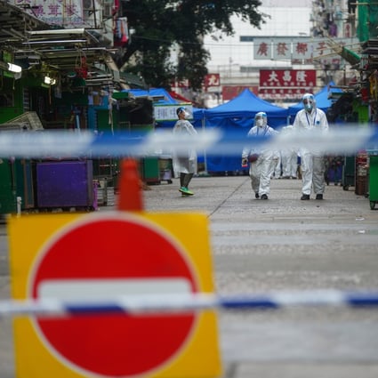 Government officers stand guard at the perimeter of the lockdown zone in Yau Ma Tei. Photo: Sam Tsang