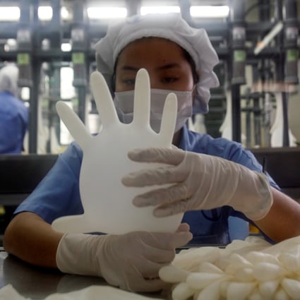 A worker at a Top Glove factory outside Kuala Lumpur, Malaysia. Photo: Reuters