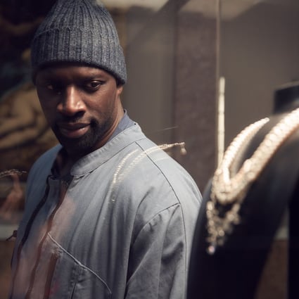 Omar Sy, as Assane Diop in Lupin, sizes up the target of his next heist from the Louvre Museum in the French hit series on Netflix. Photo: TNS