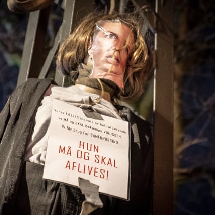 An effigy representing Danish Prime Minister Mette Frederiksen with a sign around her neck reading “She must be put down” is pictured before being set alight in Copenhagen, Denmark on Sunday. Photo: EPA-EFE