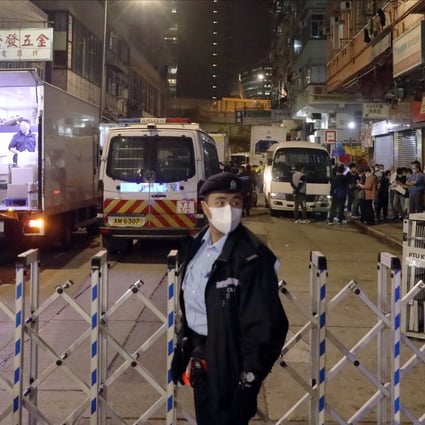 A police officer stands guard after 12 residential buildings in Yau Ma Tei were placed under lockdown. Photo: K.Y. Cheng