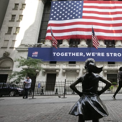 In this July 9, 2020 file photo, the Fearless Girl statue stands in front of the New York Stock Exchange in New York. Wall Street bankers in Asia are enjoying more bonuses that come with a revival in deal flows in the region. Photo: AP