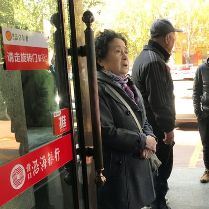 Elderly depositors seek information about the safety of their savings at a branch of Yingkou Costal Bank in Yingkou, Liaoning province, in 2019, when a run on the bank took place. Photo: Reuters