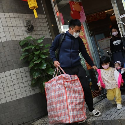 Close-contact residents evacuate Block 5 of Laguna City in Kwun Tong before moving to quarantine centres on January 25. At least 10 people, including four helpers, from five units in the 27-story block were infected with the coronavirus. Photo: K.Y. Cheng