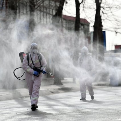 Workers in protective suits spray disinfectant in Gaocheng district, which was declared a high-risk area for Covid-19 in Shijiazhuang, in northern China‘s Hebei province. Photo: AFP