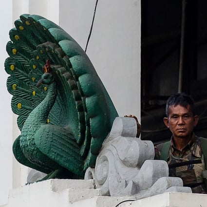 A soldier stands guard in City Hall in Yangon on February 1 after Myanmar's military seized power in a bloodless coup. Photo: AFP