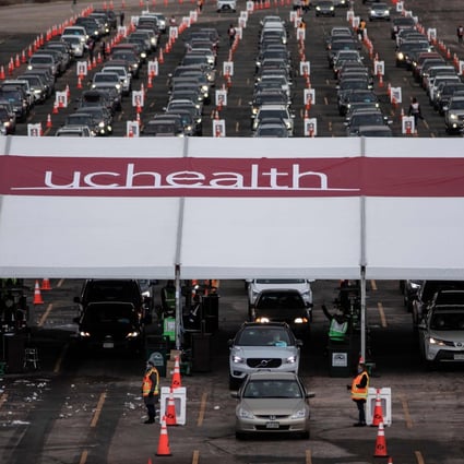 People arrive for Covid-19 vaccination at a drive-through set-up at Coors Field baseball stadium in Denver, Colorado. Photo: AFP