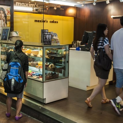 A customer views the cakes at a Maxim’s shop in Central Hong Kong. Photo: AFP