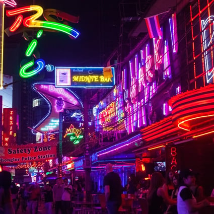 The nightlife and characters of places such as Soi Cowboy (pictured), a street in Bangkok’s red light district, has given expat crime writers inspiration for their colourful stories. Photo: Getty Images