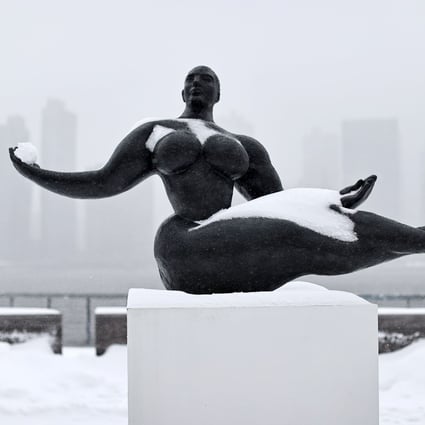 A Floating Woman statue is seen in New York during a winter storm on Monday. Photo: AFP