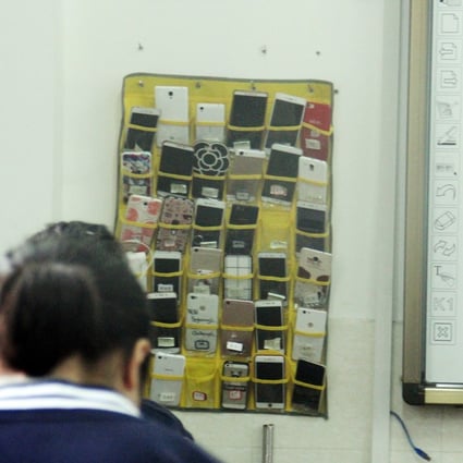 Some schools in China had already banned the use of mobile phones in class, such as a vocational school in Hangzhou, eastern China, where a rack to store students' mobile phones hangs next to the blackboard. Mobile phones have been banned from the country’s primary and secondary schools. Photo: Getty Images