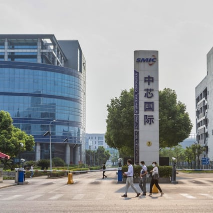 People walk in front of the gate of SMIC factory in Shanghai, China on September 7, 2020. Photo: EPA-EFE