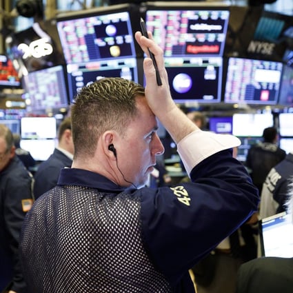A trader wipes his forehead at the opening bell at the New York Stock Exchange on 16 March 2020. Photo: EPA-EFE