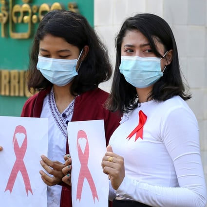 Government staff wearing red ribbons pose during a protest against the coup that ousted elected leader Aung San Suu Kyi in the capital, Naypyidaw, on Thursday. Photo: Reuters