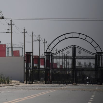 Chinese flags are seen on a road leading to a facility believed to be a re-education camp in Xinjiang. Photo: AFP