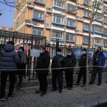 Local residents line up for mandatory coronavirus testing in Daxing district, Beijing, last month. Photo: EPA-EFE