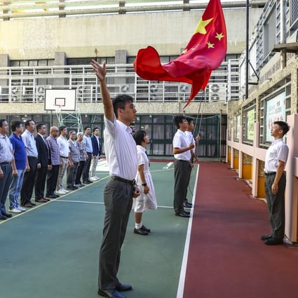 A flag-raising ceremony at Pui Kiu Middle School in North Point. Photo: Nora Tam