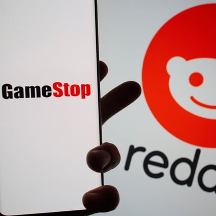 The GameStop logo is seen in front of displayed Reddit logo. Photo: Reuters