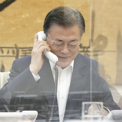 South Korean President Moon Jae-in, right, talks with his US counterpart Joe Biden over the phone on Thursday. Photo: DPA