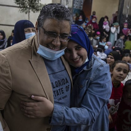 Al Jazeera journalist Mahmoud Hussein hugs his daughter after being released on Saturday by the Egyptian authorities after four years in detention. Photo: EPA-EFE