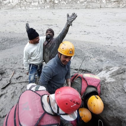 A hydropower plant worker raises his arms in joy after he was pulled out from beneath the ground during rescue operations after a portion of Nanda Devi glacier broke off in the Tapovan area. Photo: AP