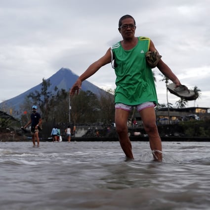 Villagers wade through floodwaters brought on by Typhoon Goni in Legaspi city, the Philippines, in November. Typhoon Goni left 20 people dead and affected two million people in the country. Photo: EPA-EFE