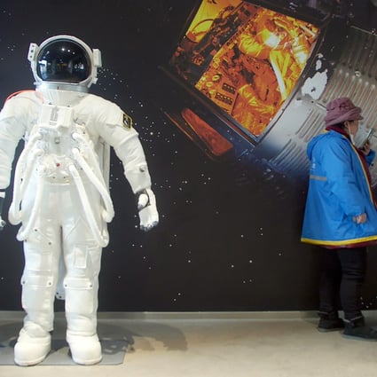 A delivery driver waits for an order at a themed cafe in Beijing, as China’s ambitious missions add to people’s interest in space. Photo: AP