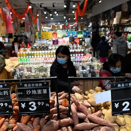 People select vegetables at a supermarket in Beijing on February 10. There is little chance of China, the growth engine of the global economy, exporting inflation any time soon. Photo: AFP