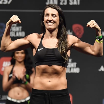 Marina Rodriguez poses on the scale during the UFC 257 weigh-in at Etihad Arena on UFC Fight Island. Photo: Jeff Bottari/Zuffa LLC