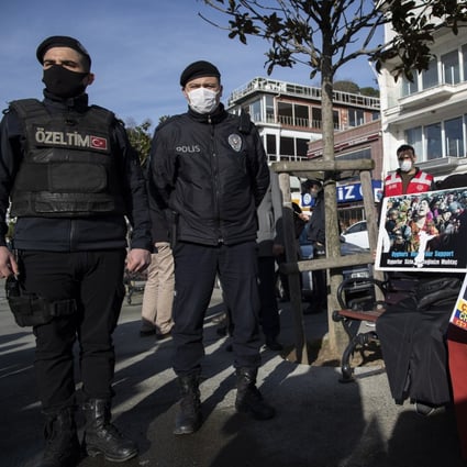 Turkish riot police stand guard as Uygurs protest near the Chinese consulate in Istanbul on Friday. Photo: EPA-EFE