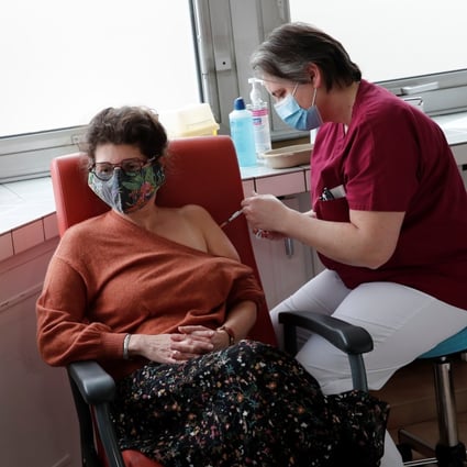 A health worker administers a Covid-19 vaccine to a colleague at the Foch hospital in Suresnes, France. Photo: Reuters