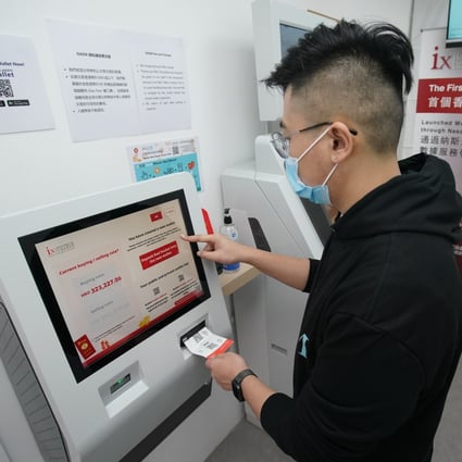 Hugo Zheng, manager of ixFintech, shows how to use a pre-provided paper wallet and QR code to buy bitcoin at a shop in Kennedy Town on February 8. Photo: Felix Wong