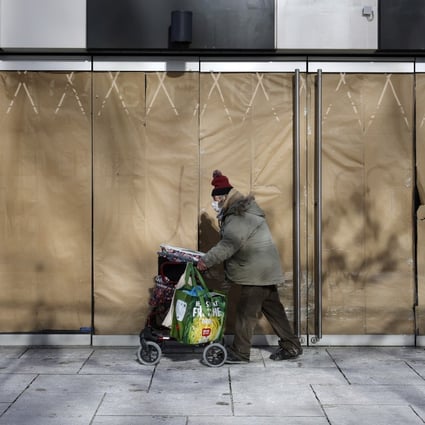 A homeless person walks in front of a closed store at a shopping street in Frankfurt, Germany, on Tuesday. Photo: EPA-EFE
