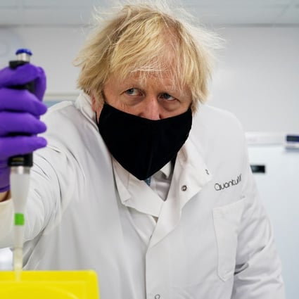 Britain’s Prime Minister Boris Johnson visits the QuantuMDx Biotechnology company. Photo: Reuters