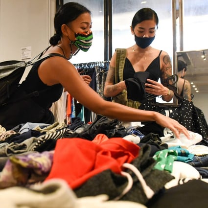 Nadia Kishlan (left) browsing through secondhand clothes at a pop-up swap event organised by a group of volunteers in Singapore. Photo: AFP