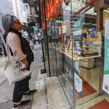 A poster for the elderly health care voucher scheme is displayed at an optical shop in Wan Chai in March 2019. Photo: Sam Tsang