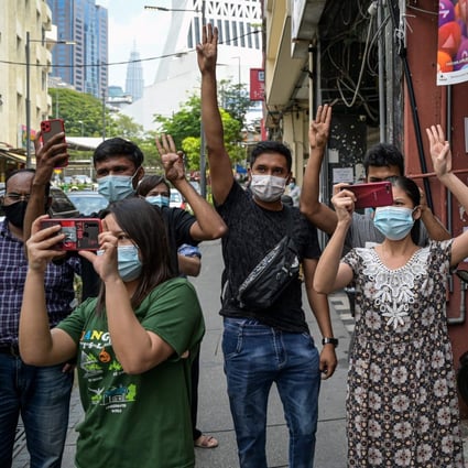 Supporters of Myanmar's National League for Democracy (NLD) give a three-fingered salute during demonstrations against the Myanmar military coup in Kuala Lumpur, Malaysia. Photo: AFP