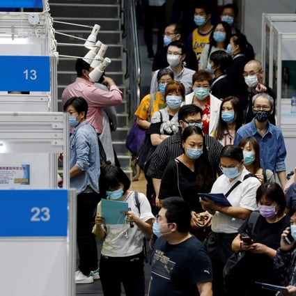 Job seekers wearing face masks fill in forms at a job fair amid the coronavirus disease (COVID-19) outbreak, in Hong Kong. Photo: Reuters