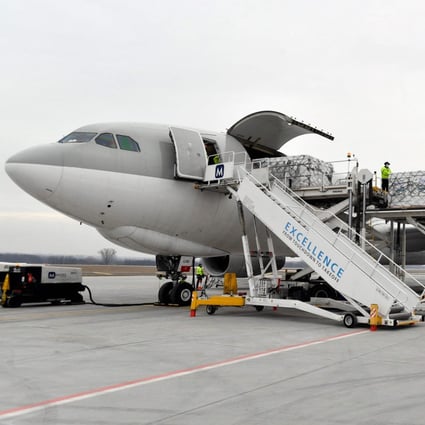 Workers in Hungary unload cargo from a plane that transported the first doses of the Chinese Sinopharm vaccine on February 16. Photo: AFP