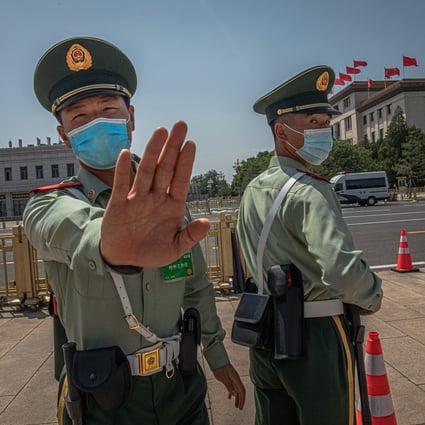 A People’s Liberation Army soldier tries to stop a photographer from taking photos at Tiananmen Square during the Communist Party's annual congress in Beijing on May 28, 2020. The events at Tiananmen Square in 1989 remain one of the most widely censored topics in China. Photo: EPA-EFE