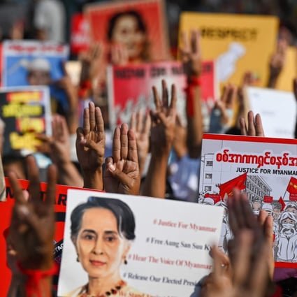 Protesters hold up the three finger salute with signs calling for the release of detained Myanmar civilian leader Aung San Suu Kyi in Yangon. Photo: AFP