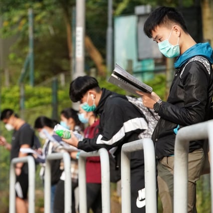 Last-minute revisions as students wait to be seated for the Diploma of Secondary Education exam at a school in Tsuen Wan in April 2020. Photo: Felix Wong