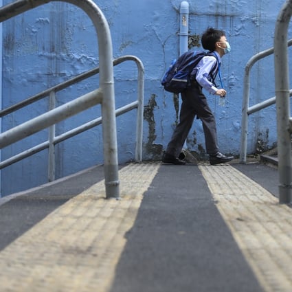 A young Hong Kong student makes his way to school in the early morning in Wan Chai on November 30, 2020. All face-to-face classes were suspended from December 2 due to a worsening fourth wave of Covid-19 in the city. Photo: Nora Tam