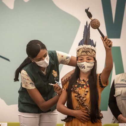 A member of the Witoto indigenous tribe receives the Sinovac coronavirus vaccine in Manaus, Brazil, on January 18, 2021. Photo: Bloomberg