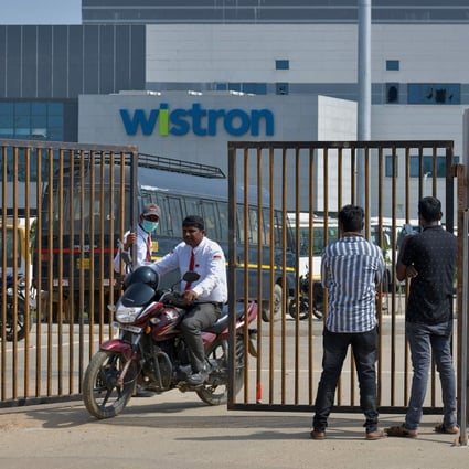People exit from the gate of Wistron, a Taiwanese-run iPhone factory at Narsapura, about 60 km from Bangalore on December 13, 2020. Photo: AFP