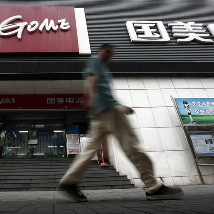 A man walks past a Gome store in Shanghai, China on August 26, 2013. Photo: Reuters