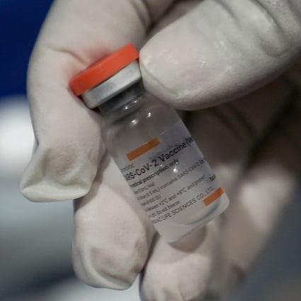 A healthcare worker holds a vial of the Sinovac Covid-19 vaccine in Jakarta, Indonesia. Photo: Bloomberg